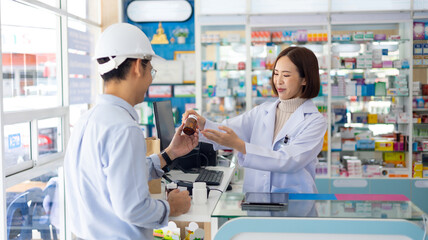 consulting, Medicine imformation, Caucasian female customer or patient. Asian male pharmacists explaining how to take drugs to treat diseases correctly at Pharmacy Drugstore.  Health and wellness 