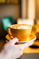 Woman hands holding cup of hot coffee latte cappuccino