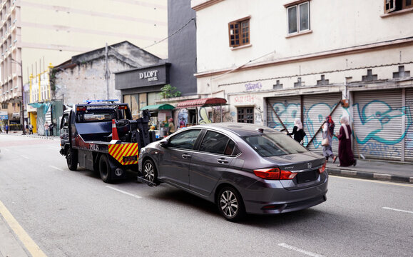 Police towing a car in Chinatown street in Kuala Lumpur, Malaysia on August 6, 2022