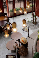Woman sitting in a coffee shop and taking selfie