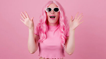 Surprised fashionable woman, total pink, hands up wonder, shocked. Wow! Amazed screaming lady...