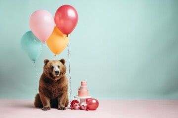 a brown bear stands near a big cake and balloons near a pink floor on a green wall background - obrazy, fototapety, plakaty