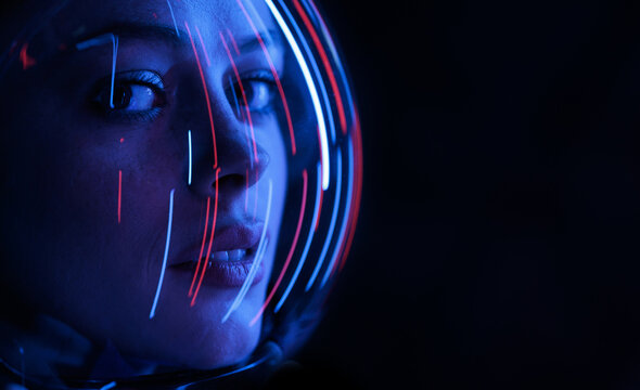 Astronaut in futuristic costume. Girl in glasses of virtual reality while touching air. Augmented reality game, future technology, AI concept. Dark background.