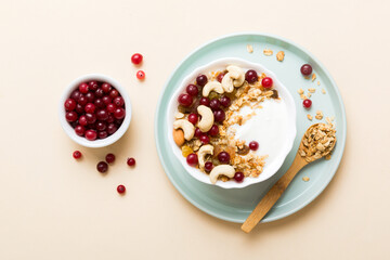 Healthy breakfast food with granola, yogurt, fruits and nuts. Dessert parfait with dried fruits for breakfast
