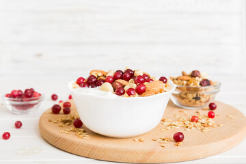 Healthy breakfast food with granola, yogurt, fruits and nuts. Dessert parfait with dried fruits for breakfast