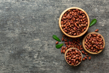 Fresh healthy peanuts in bowl on colored table background. Top view Healthy eating bertholletia concept. Super foods