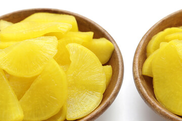 Sweet and tart slices of yellow pickled daikon, known as takuan in Japan and danmuji in Korea.
