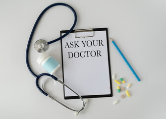 Card sign with Ask your Doctor text message isolated on hospital clinic office background. Retro instagram style filter image. Healthcare concept - obrazy, fototapety, plakaty