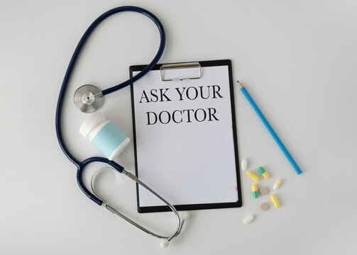 Card sign with Ask your Doctor text message isolated on hospital clinic office background. Retro instagram style filter image. Healthcare concept