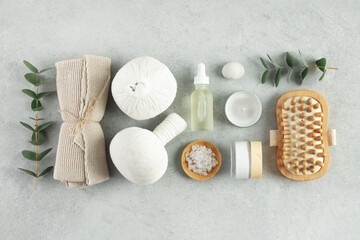 Top view photo of Spa set with massage herbal balls on grey background top view copy space