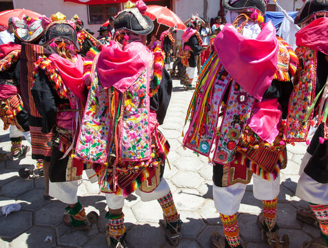 Pujillay festival in the town of Tarabuco, Bolivia. People are dancing wearing traditional clothes and wooden shoes called ojotas