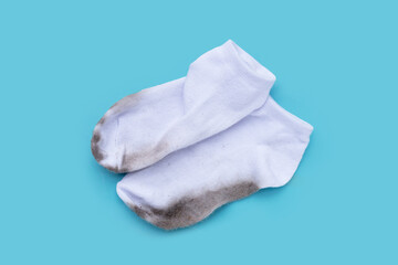 Dirty white socks on blue background.