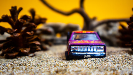 Minahasa, Indonesia - December 9, 2022: a toy car among the pinecones