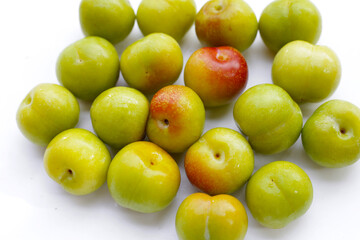 Fresh green plum on white background
