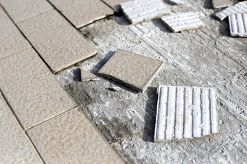 Cracked brown tiles on cement floor