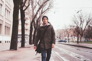 young beautiful self confident man outdoor walking in the street