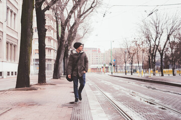 Fototapeta na wymiar young adult man walking in the street and looking further