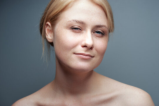Natural beauty. Close-up studio portrait of a young woman with naked shoulders