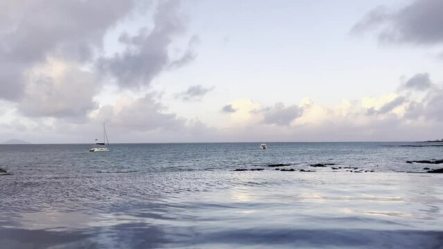 Infinity pool overlooking the ocean in Mauritius, surrounded by tropical scenery. Luxury resort atmosphere capturing a relaxing island vacation and breathtaking Indian Ocean views.