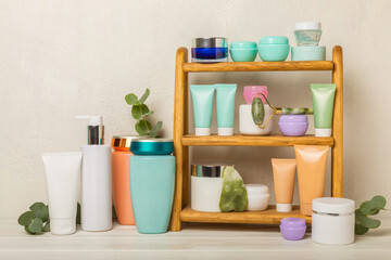 Skin care stage for healthy skin - face serum and lotion, scrub, peeling and cleanser on white wooden background. The concept of beauty and cosmetics. A set of cosmetics on a wooden shelf