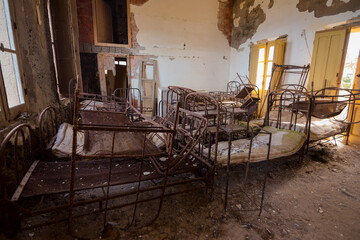 Metal beds with creepy dolls inside abandoned orphanage