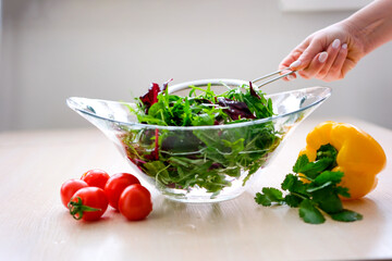 Hand of maid washing tomato fresh vegetables preparation healthy food in kitchen Super Slow Motion Shot of Flying Cuts of Colorful Vegetables and Water Drops 