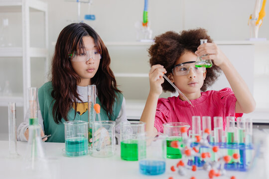 Afro black kid diversity children playing in science chemical lab for learning education in school with friend