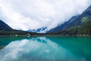 Scenic Mountain Lake Landscape with Cloudy Sky in Rasen-Antholz, Ital