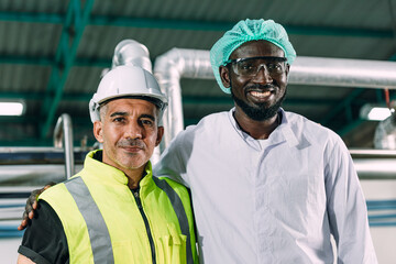 Portrait happy senior engineer with hygiene black african male worker standing together friendly in food factory industry