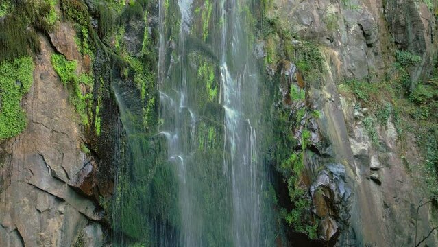 Aguacaida Waterfall (Fervenza de Augaca&iacute;da) On Mossy Cliffs In Panton, Lugo, Spain. - aerial ascend