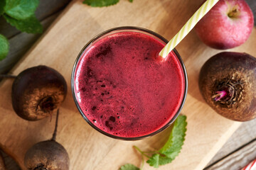 A glass of beetroot juice with fresh apples and melissa leaves - obrazy, fototapety, plakaty