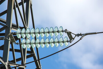 High voltage tower with electrical voltage wires isolates close-up against the background of...