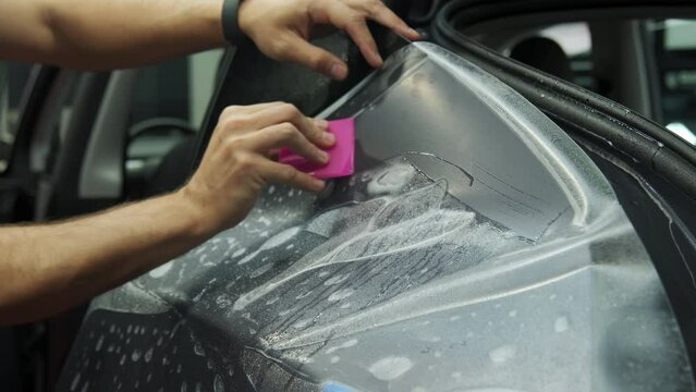 Closeup view of Process of applying a protective PPF film to a car. applying a protective film. 