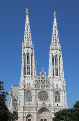 Fototapeta na wymiar Two white bell towers of the VOTIVE CHURCH in Wien in Austria In Central Europe