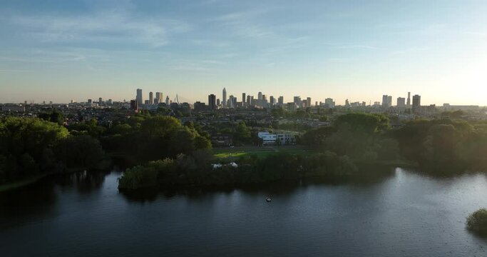 Revealing aerial of the Rotterdam skyline in the distance. Seen from the Kralingse plas.