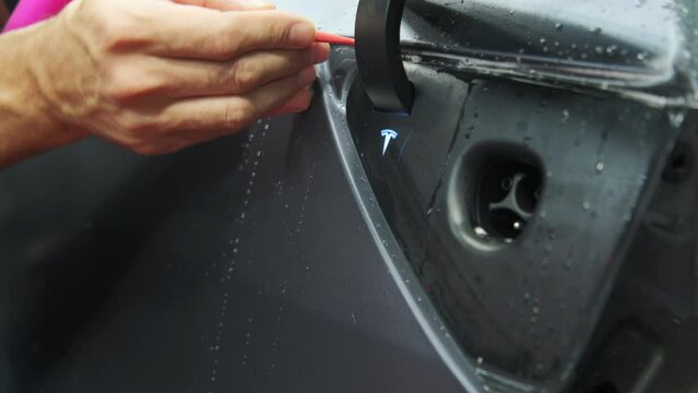 Process of applying a protective PPF film to ac Tesla car. Naperville IL. USA 03.25.23
