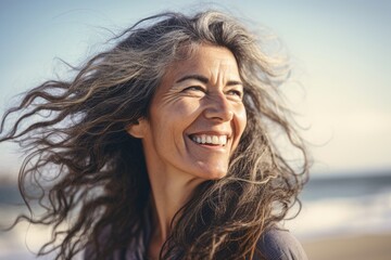 Happy elder woman with loose hair in the wind