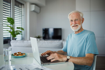 Senior man in a wheelchair working during retirement.