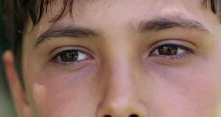 Young boy closing eyes in contemplation and meditation. Pensive thoughtful child opening eye