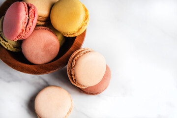 Colorful Macaroons overflowing from bowl
