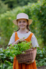 Portrait of a cute little girl in an autumn garden.