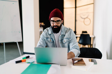 Focused man working on laptop in office