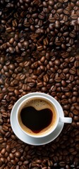 Naklejka premium Cup of coffee with heart shape on the cup with coffee beans on the background
