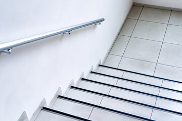Staircase in a modern office building. Staircase - emergency exit in a hotel, close-up of the stairs. Emergency exit via stairs in a modern building. Staircase in a modern house