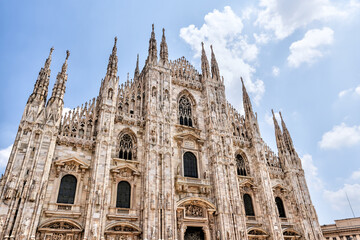 Fototapeta premium Milan, Italy - July 12, 2022: Exterior views of the Duomo Cathedral in Milan 