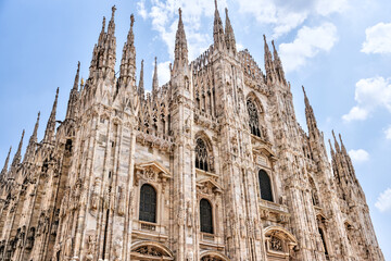 Fototapeta premium Milan, Italy - July 12, 2022: Exterior views of the Duomo Cathedral in Milan 