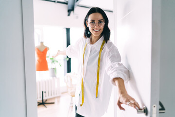 Smiling designer welcoming in own studio