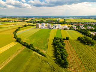Drone view of vineyards wheat rape seed fields in southern Vienna with apartment buildings