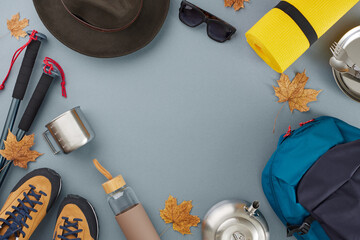 Autumn-ready hiking equipment. Top view flat lay of tourism equipment, hat, sunglasses, fallen...