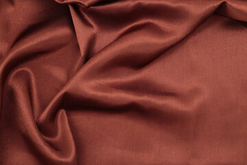 Brown pearl wave silk fabric. Abstract texture copy space background.